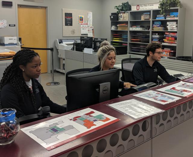 Student employees working at the Resource Room front desk.