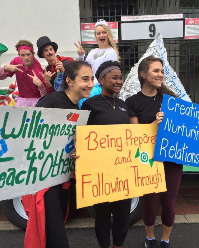 Mount Leadership Society students holding signs with Mount's 5 essentials